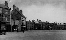 College Square, showing what is now Trevor's Fish and Chip shop, and Y'Thai restaurant. There is a motorised vehicle outside what is now SPAR College Square, showing what is now Trevor's Fish and Chip shop, and Y'Thai restaurant. There is a motorised vehicle outside what is now SPAR