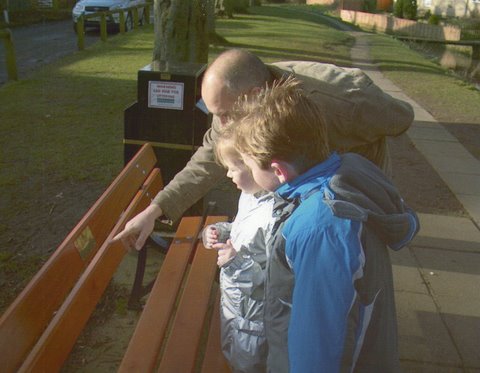 Karl, George, and Hannah reading the dedication